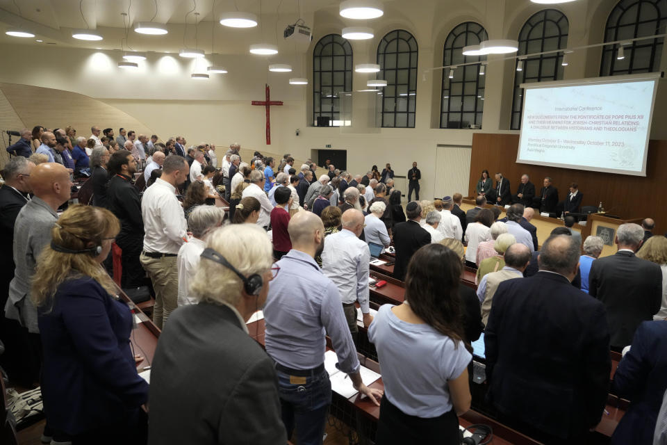 Participants at the international conference "New documents from the Pontificate of Pope Pius XII and their Meaning for Jewish-Christian Relations: A Dialogue Between Historians and Theologians", observe a minute of silence for the Israeli and Palestinian victims, as they gather at the Gregorian University in Rome, Monday, Oct. 9, 2023. (AP Photo/Gregorio Borgia)