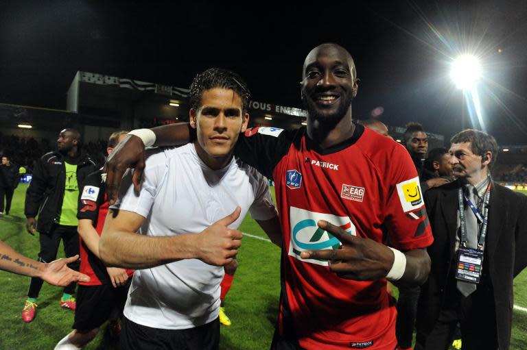 Guingamp's French forward Mustapha Yatabare (R) and Guingamp's French defender Dorian Leveque (L) celebrate after winning the French Cup football match Guingamp against Monaco on April 16, 2014 at the Roudourou stadium in Guingamp, western of France