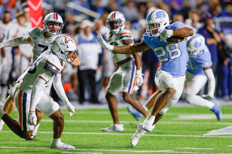 Chapel Hill, North Carolina, USA; North Carolina Tar Heels running back Omarion Hampton runs the ball against the Virginia Cavaliers in the second half at Kenan Memorial Stadium.