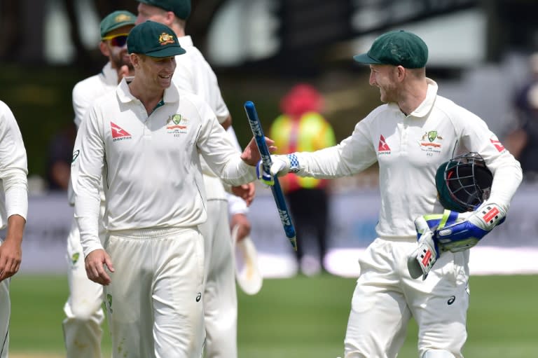 Australia's Adam Voges (L) and teammate Peter Nevill walk from the field after their win during day four of the first Test against New Zealand in Wellington on February 15, 2016