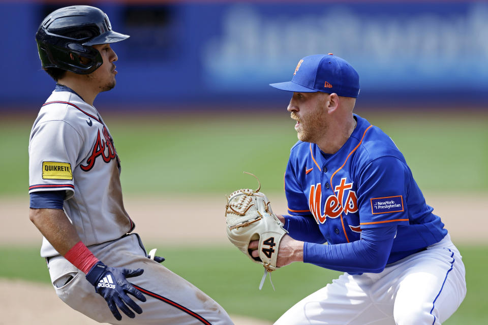 New York Mets pitcher Reed Garrett tags out Atlanta Braves' Nicky Lopez during the seventh inning in the first baseball game of a doubleheader on Saturday, Aug. 12, 2023, in New York. (AP Photo/Adam Hunger)