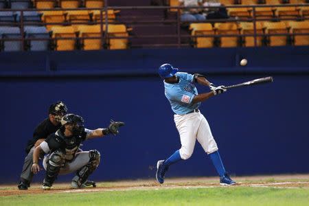 Jorge Padilla of Los Artesanos de Las Piedras hits during a baseball game against Los Halcones de Gurabo during the Puerto Rico Double A baseball league at Las Piedras, Puerto Rico, June 11, 2016. REUTERS/Alvin Baez