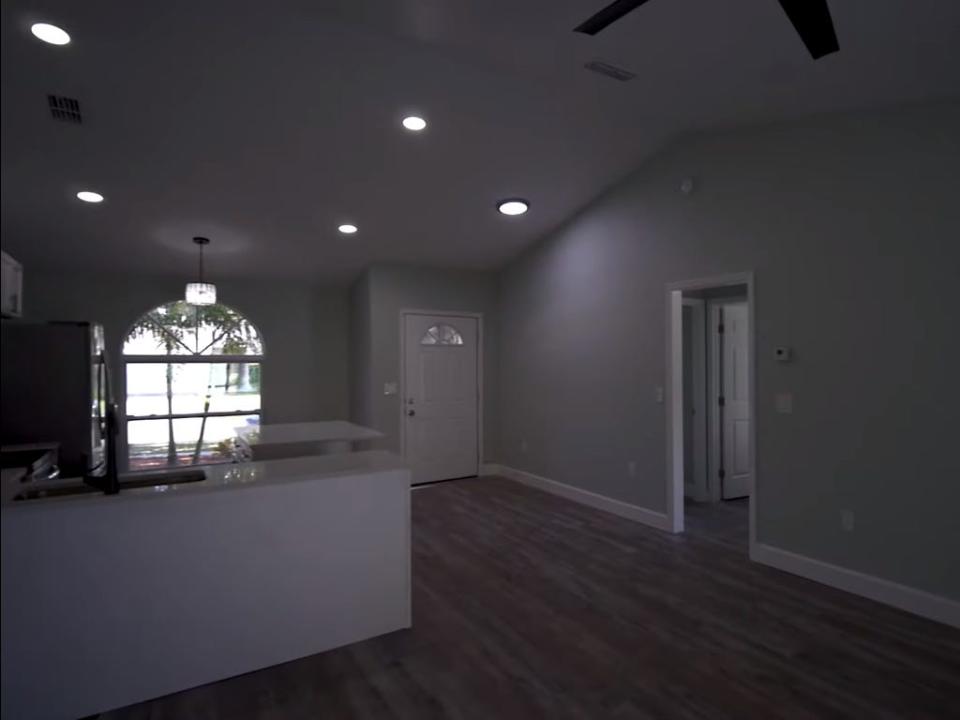 A photo of a gray-walled kitchen with a white countertop.