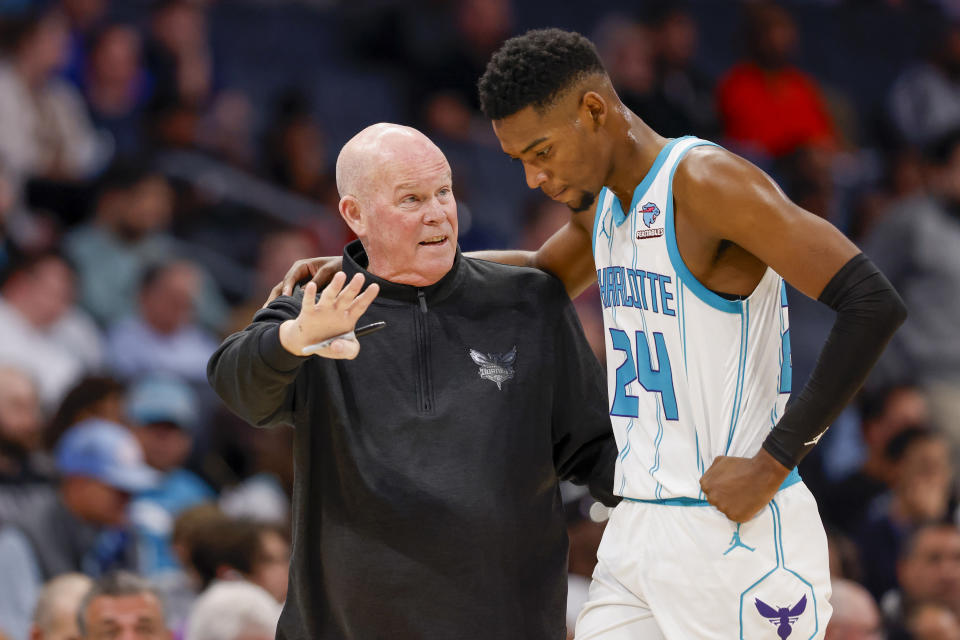 Charlotte Hornets head coach Steve Clifford, left, talks to forward Brandon Miller (24) during a timeout as Charlotte plays against the Washington Wizards during the first half of an NBA basketball game in Charlotte, N.C., Wednesday, Nov. 8, 2023. (AP Photo/Nell Redmond)