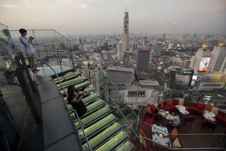 Visitors and tourists enjoy the view from a rooftop bar in central Bangkok April 1, 2015. REUTERS/Damir Sagolj