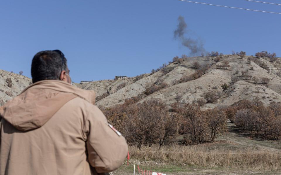 A de-miner working for Mine Advisory Group watches a controlled detonation of landmines planted during the Iran-Iraq war - Sam Tarling /Sam Tarling 