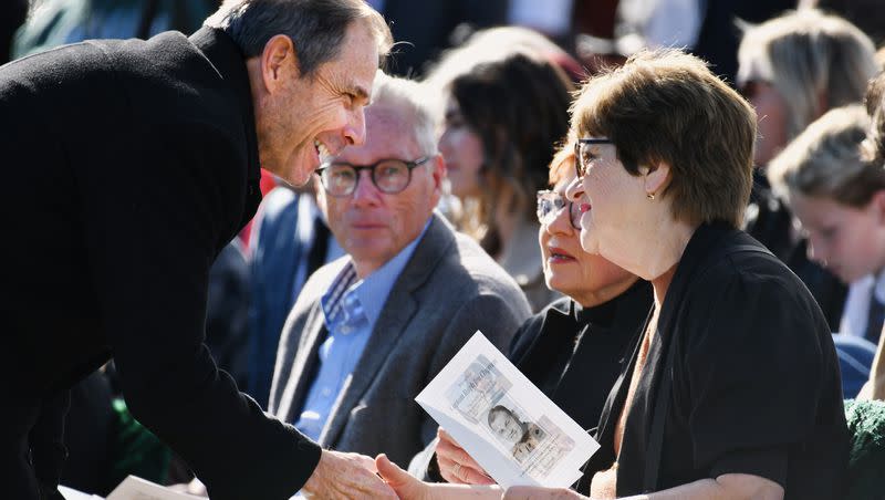 U.S. Rep. John Curtis, R-Utah, greets the family of U.S. Marine Corps Capt. Ralph Jim Chipman during a memorial service at American Fork city cemetery on Saturday, Nov. 11, 2023. The soldier’s remains were identified and returned to his family 50 years after he was lost in battle in Vietnam.