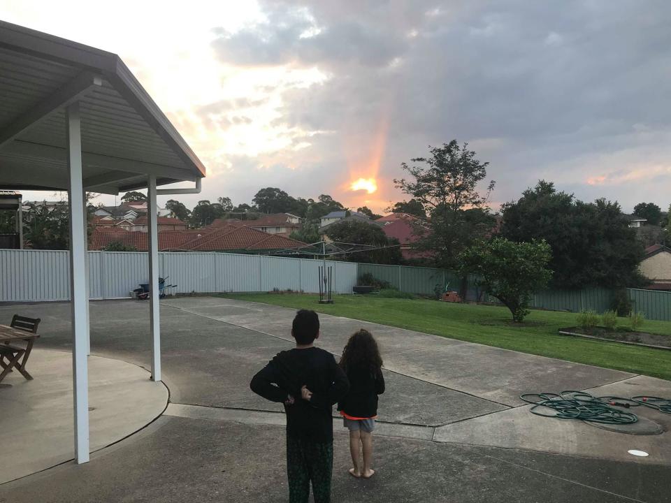Mr Ruisi's children watch the sunset from his backyard (Santino Ruisi )