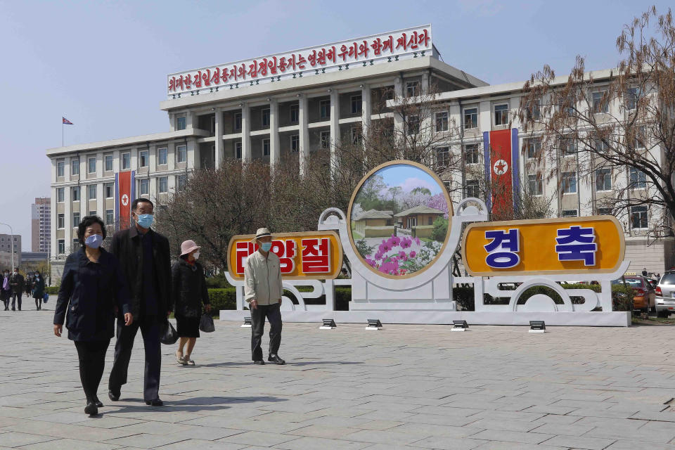 People walk in a street near the Arch of Triumph on the Day of the Sun, the birth anniversary of late leader Kim Il Sung, in Pyongyang, North Korea Thursday, April 15, 2021. (AP Photo/Cha Song Ho)