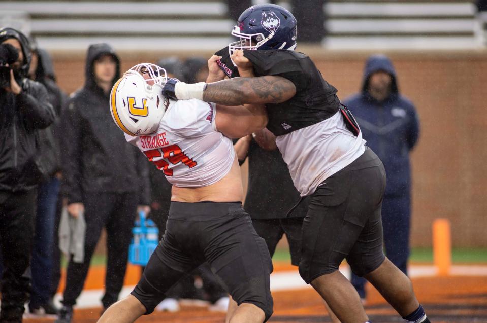 Feb 2, 2022; Mobile, AL, USA;  National offensive lineman Cole Strange of Tennessee-Chattanooga (69) spars with National defensive lineman Travis Jones of Connecticut (57) during National practice for the 2022 Senior Bowl in Mobile, AL, USA.  Mandatory Credit: Vasha Hunt-USA TODAY Sports