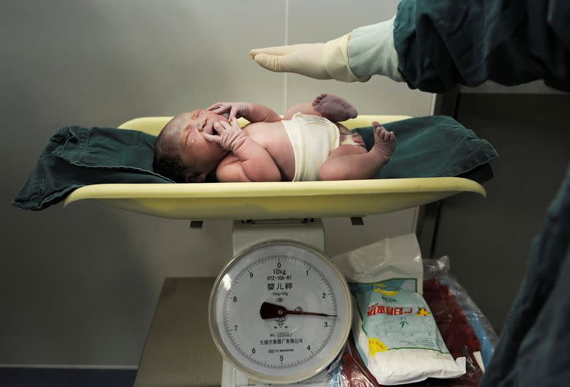 FILE PHOTO: A newborn baby is weighed after it was born at a hospital in Hefei