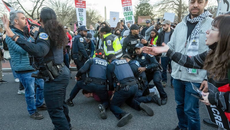 A man is arrested after driving his vehicle near protesters at a rally demanding a permanent cease-fire and end to U.S. funding to Israel near the White House on Wednesday, March 7, 2024, in Washington.