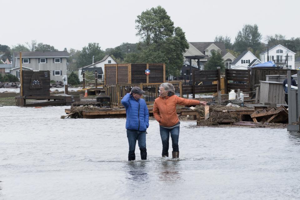 Residents stand in flood waters following the passing of Hurricane Fiona, later downgraded to a post-tropical cyclone, in Shediac, New Brunswick, (REUTERS)