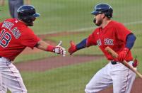 <p>Boston Red Sox Mitch Moreland, left, is greeted by teammate Alex Verdugo after he hit a first inning three-run home run. The Boston Red Sox host The Toronto Blue Jays in an exhibition baseball game at Fenway Park in Boston on July 21.</p>