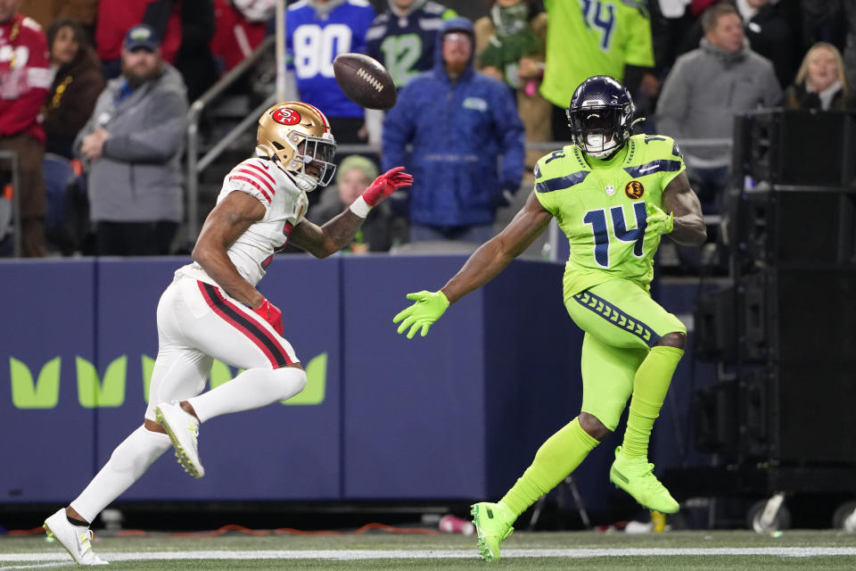 San Francisco 49ers cornerback Charvarius Ward, left, breaks up a pass intended for Seattle Seahawks wide receiver DK Metcalf (14) during the second half of an NFL football game, Thursday, Nov. 23, 2023, in Seattle. (AP Photo/Lindsey Wasson)