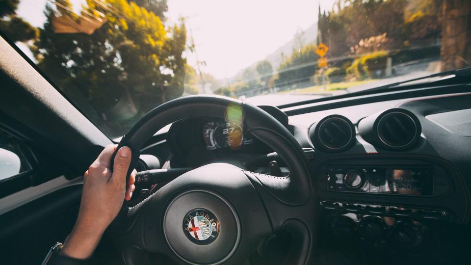 Hands on an Alfa Romeo steering wheel