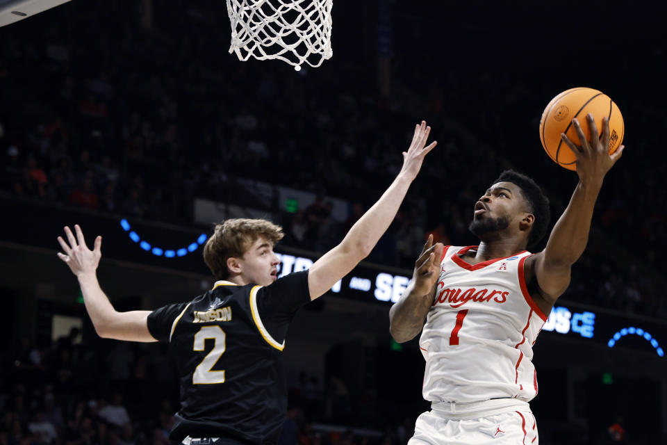 Houston guard Jamal Shead (1) shoots as Northern Kentucky guard Sam Vinson (2) defends during the first half of a first-round college basketball game in the men's NCAA Tournament in Birmingham, Ala., Thursday, March 16, 2023. (AP Photo/Butch Dill)