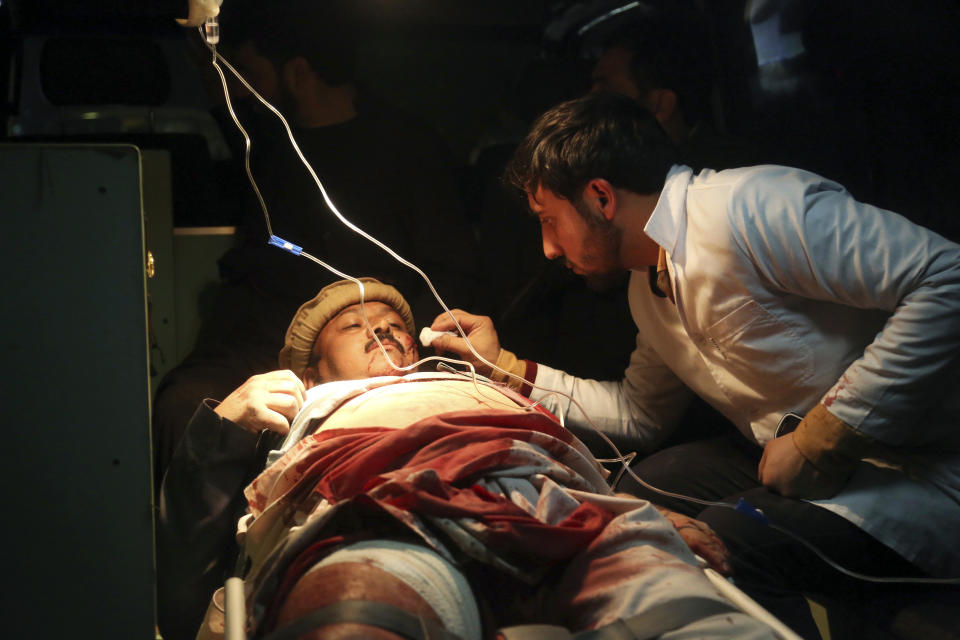 FILE - In this Oct. 20, 2018 file photo, an injured man receives treatment in an ambulance after a suicide attack in Kabul, Afghanistan. The United Nations Assistance Mission in Afghanistan said in a new report released Tuesday, Nov. 6, 2018, that 56 civilians were killed and 379 others wounded in attacks during the recent parliamentary election. The numbers reveal that more civilians were harmed in this year’s election violence than in four previous Afghanistan national elections. (AP Photo/Rahmat Gul, File)