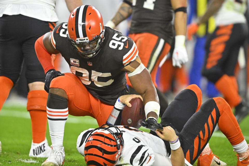 Cleveland Browns defensive end Myles Garrett (95) kneels over Cincinnati Bengals quarterback Joe Burrow after sacking him during the second half of an NFL football game in Cleveland, Monday, Oct. 31, 2022. (AP Photo/David Richard)