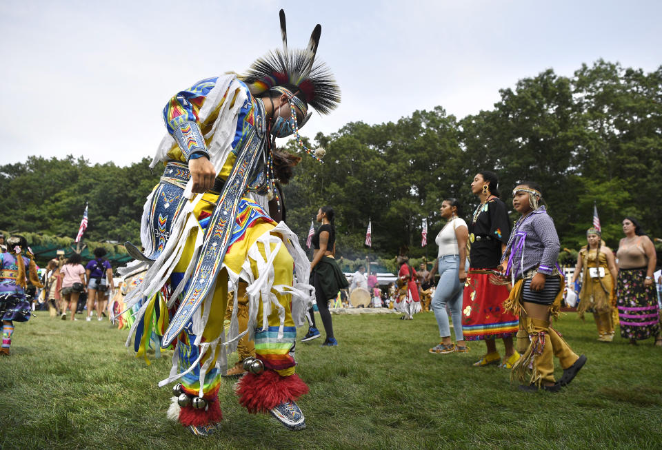 A dancer participates in an intertribal dance at Schemitzun on the Mashantucket Pequot Reservation in Mashantucket, Conn., Saturday, Aug. 28, 2021. Connecticut and a handful of other states have recently decided to mandate students be taught about Native American culture and history. (AP Photo/Jessica Hill)