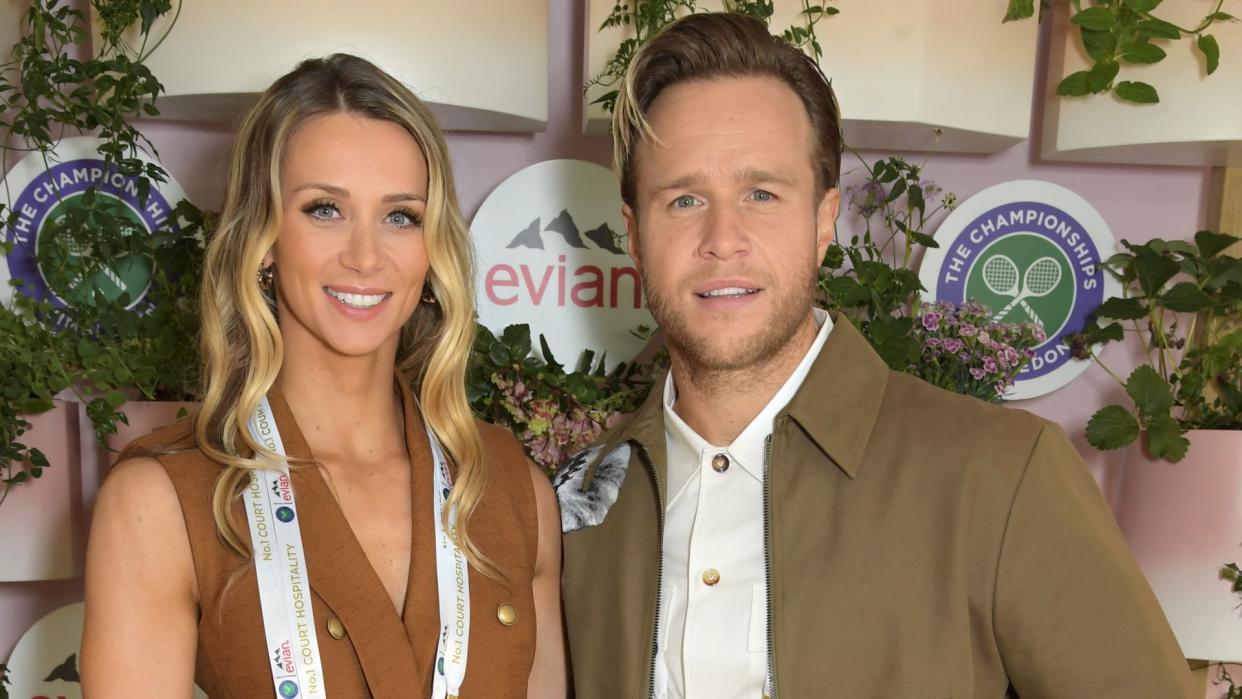 Amelia Tank and Olly Murs pose in Evian's VIP suite in 2021