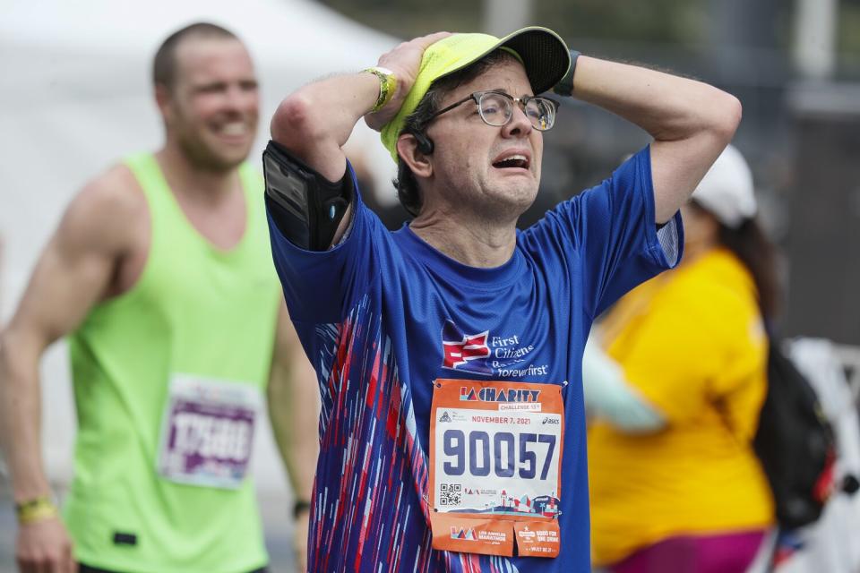 Bob Binnie weeps as he crosses the finish line.