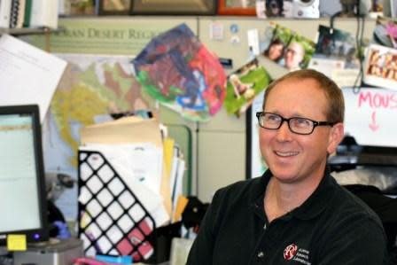 Taylor Edwards, assistant staff scientist with the UAGC and doctoral candidate in the UA School of Natural Resources and the Environment, describes his work with the core and his collegial working relationship with Ryan Sprissler. (Photograph by Susan E. Swanberg).