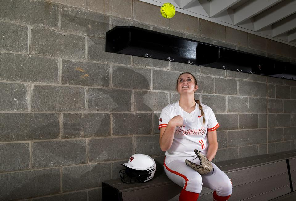 Beech Grove sophomore Malone Moore is a standout softball pitcher who also plays soccer and basketball for the Hornets. Pictured, Moore tosses a softball for a portrait in the dugout on Wednesday, March 30, 2022, in Beech Grove, Ind. 