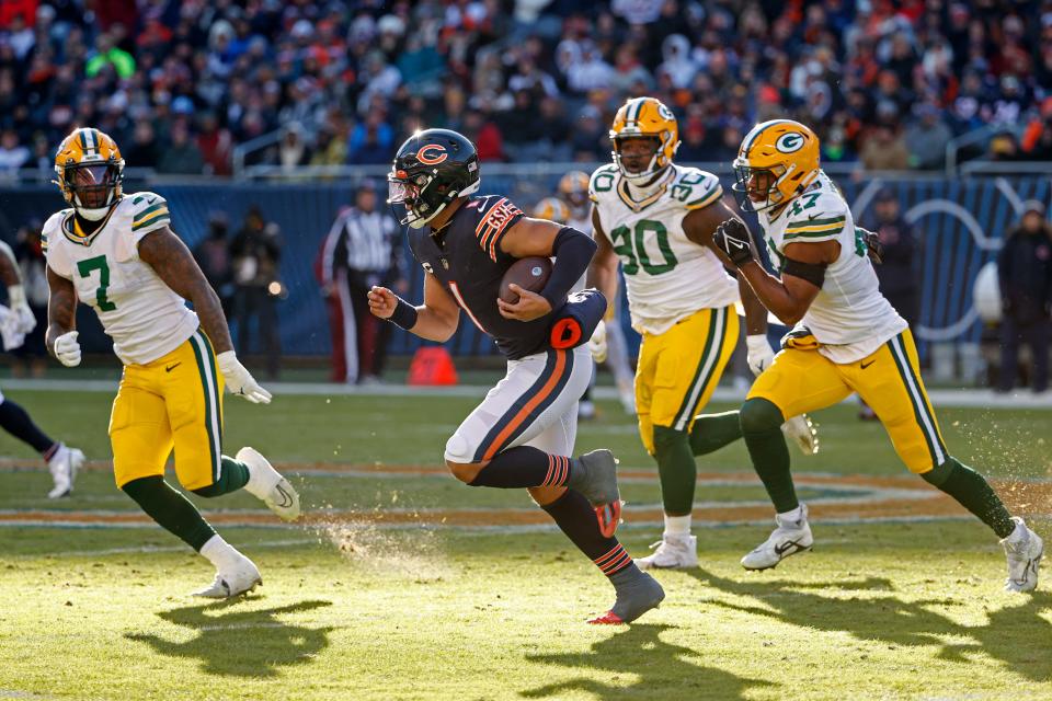 Chicago Bears quarterback Justin Fields (1) runs with the ball during the second half against the Green Bay Packers on Sunday, Dec. 4, 2022, in Chicago.