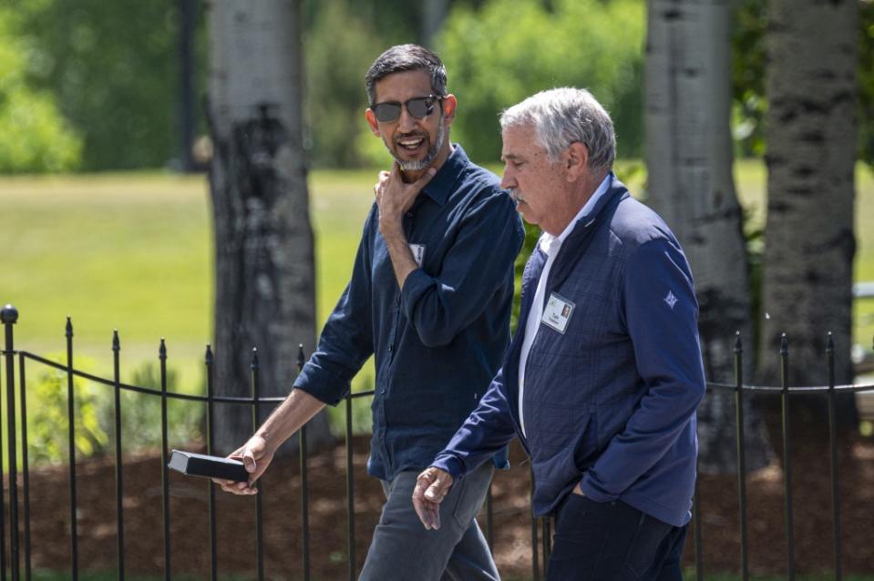 Sundar Pichai, chief executive officer of Alphabet Inc., left and Tom Friedman, foreign affairs columnist for the New York Times, walk to lunch during the Allen & Co. Media and Technology Conference in Sun Valley, Idaho, US, on Thursday, July 13, 2023. The summit is typically a hotbed for etching out mergers over handshakes, but could take on a much different tone this year against the backdrop of lackluster deal volume, inflation and higher interest rates. Photographer: David Paul Morris/Bloomberg via Getty Images