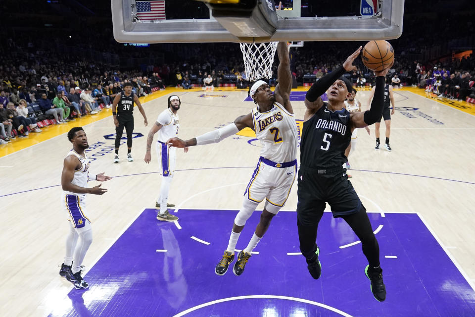 Orlando Magic forward Paolo Banchero (5) shoots over Los Angeles Lakers forward Jarred Vanderbilt (2) during the first half of an NBA basketball game Sunday, March 19, 2023, in Los Angeles. (AP Photo/Marcio Jose Sanchez)