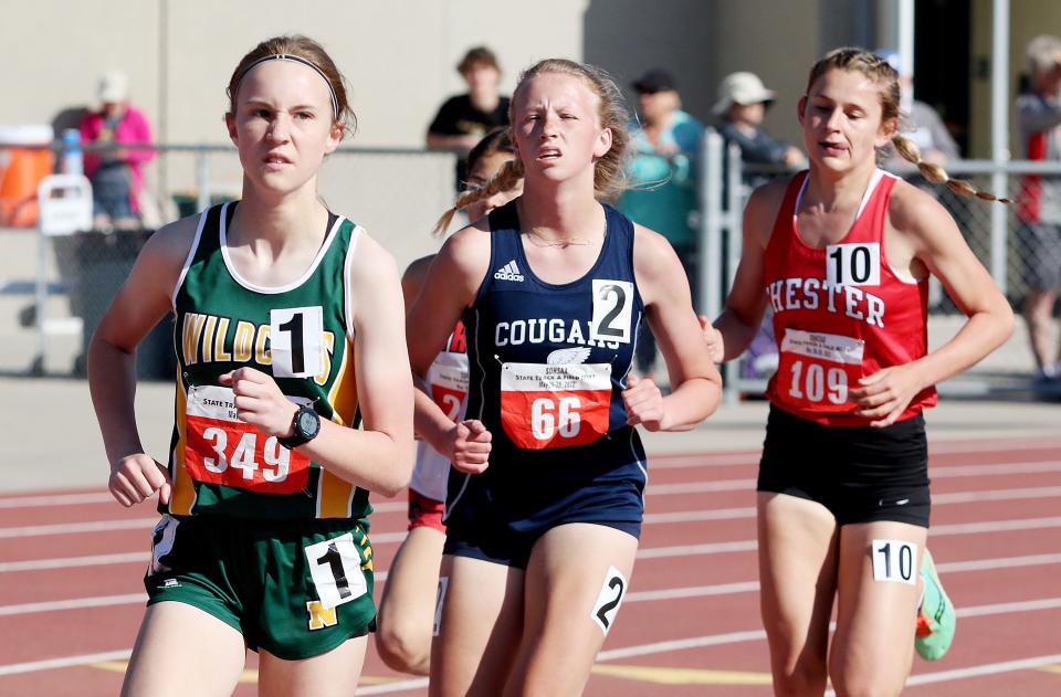 Northwestern's Ella Boekelheide (left) and Burke's Kailee Frank (center) finished first and second, respectively, in the Class B girls' 1,600-meter run during the 2022 South Dakota High School Track and Field Championships at Howard Wood Field in Sioux Falls.