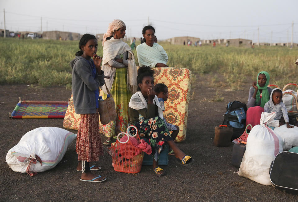 Ethiopian refugees gather n Qadarif region, easter Sudan, Sunday, Nov. 15, 2020. Thousands of Ethiopians fled the war in Tigray region into Sudan. (AP Photo/Marwan Ali)