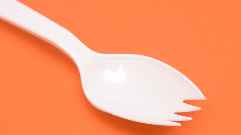 Metal spork on white background