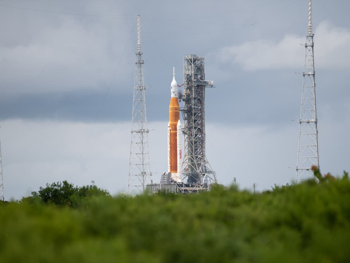 NASA's mighty Space Launch System rocket sits on its launch pad awaiting its first test, sending an uncrewed spacecraft — Orion — to the moon.  (Joel Kowsky/NASA - image credit)