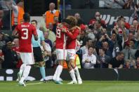 <p>Manchester United’s Marouane Fellaini celebrates scoring their first goal with teammates </p>