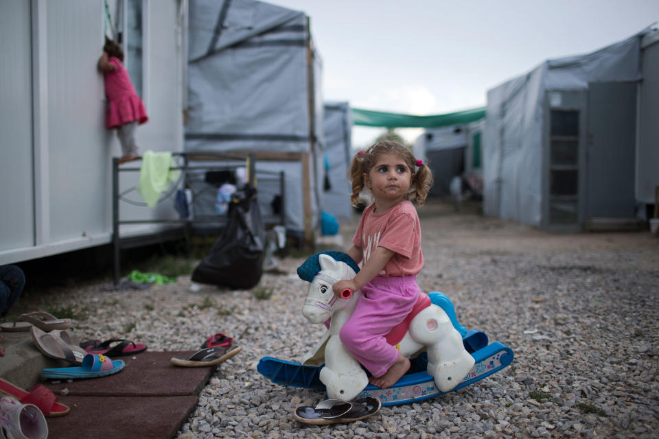 <p>Three-year-old Ragika from Syria plays with a toy horse at the refugee camp of Ritsona about 86 kilometers (53 miles) north of Athens, Greece, May 25, 2017. (Photo: Petros Giannakouris/AP) </p>