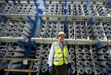 Poseidon Water project manager Peter MacLaggen stands next to some reverse osmosis filters as work continues on the Western Hemisphere's largest seawater desalination plant in Carlsbad, California, April 14, 2015. REUTERS/Mike Blake