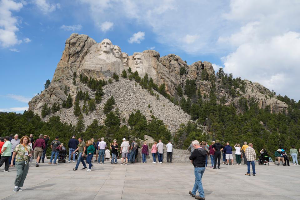 Visitors take in the massive sculpture carved into Mount Rushmore at the Mount Rushmore National Memorial Thursday, Sept. 21, 2023, in, Keystone, S.D.