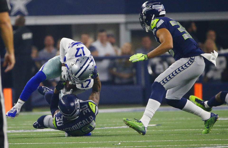 Dallas Cowboys wide receiver Allen Hurns (17) is hit by Seattle Seahawks strong safety Bradley McDougald (30) during the first half of the NFC wild-card NFL football game in Arlington, Texas, Saturday, Jan. 5, 2019. (AP Photo/Ron Jenkins)