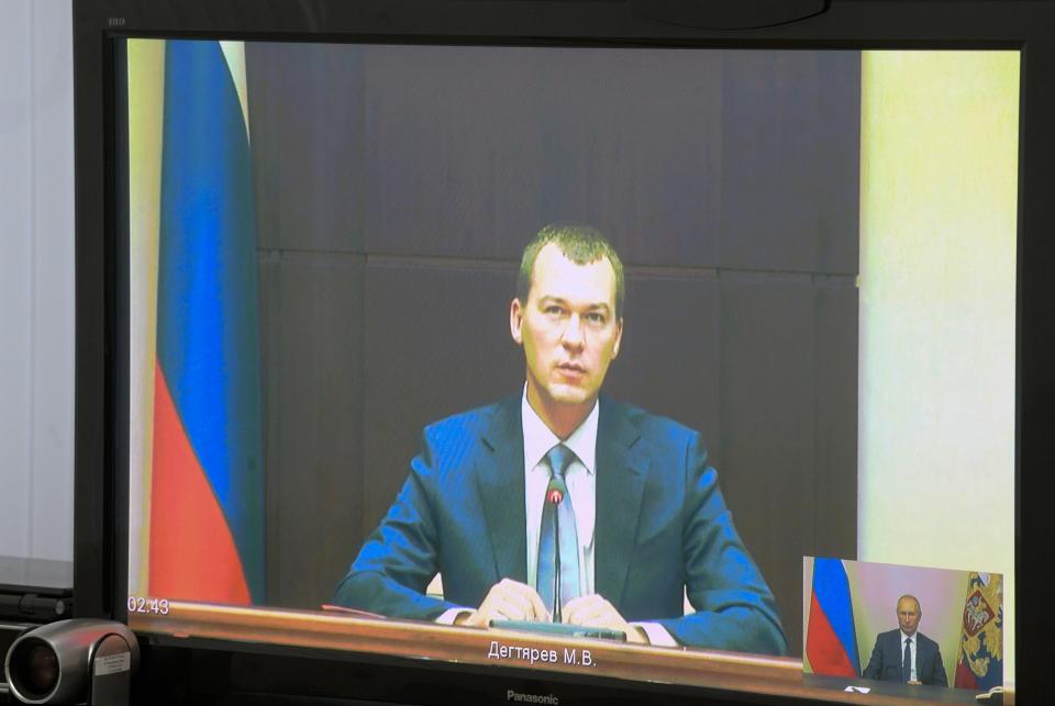 Liberal Democratic Party lawmaker Mikhail Degtyarov is seen on a TV screen during a video conference with Russian President Vladimir Putin in Kerch, Crimea, Monday, July 20, 2020. Russian President Vladimir Putin on Monday appointed lawmaker Mikhail Degtyarov acting governor of the Kharaborvsk region. His predecessor Sergei Furgal was arrested on Murder charges on July 9. Tens of thousands of people have been protesting Furgal's arrest ever since. (Alexei Druzhinin, Sputnik, Kremlin Pool Photo via AP)