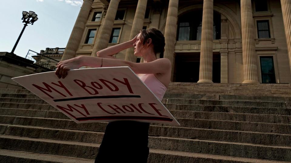 PHOTO: In this June 24, 2022 file phoyo, Zoe Schell, from Topeka, Kan., stands on the steps of the Kansas Statehouse during a rally to protest the Supreme Court's ruling on abortion, June 24, 2022, in Topeka.  (Charlie Riedel/AP, FILE)
