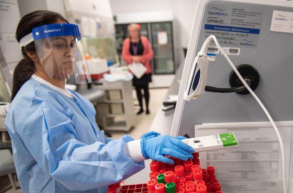 LAKE SUCCESS, NY - MARCH 11: A lab technician begins semi-automated testing for COVID-19 at Northwell Health Labs on March 11, 2020 in Lake Success, New York.  An emergency use authorization by the FDA allows Northwell to move from manual testing to semi-automated.  (Photo by Andrew Theodorakis/Getty Images)