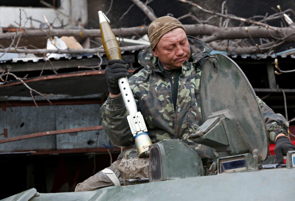 A service member of pro-Russian troops loads rocket-propelled grenades into an infantry combat vehicle during fighting in Ukraine-Russia conflict near a plant of Azovstal Iron and Steel Works company in the southern port city of Mariupol, Ukraine April 12, 2022. REUTERS/Alexander Ermochenko