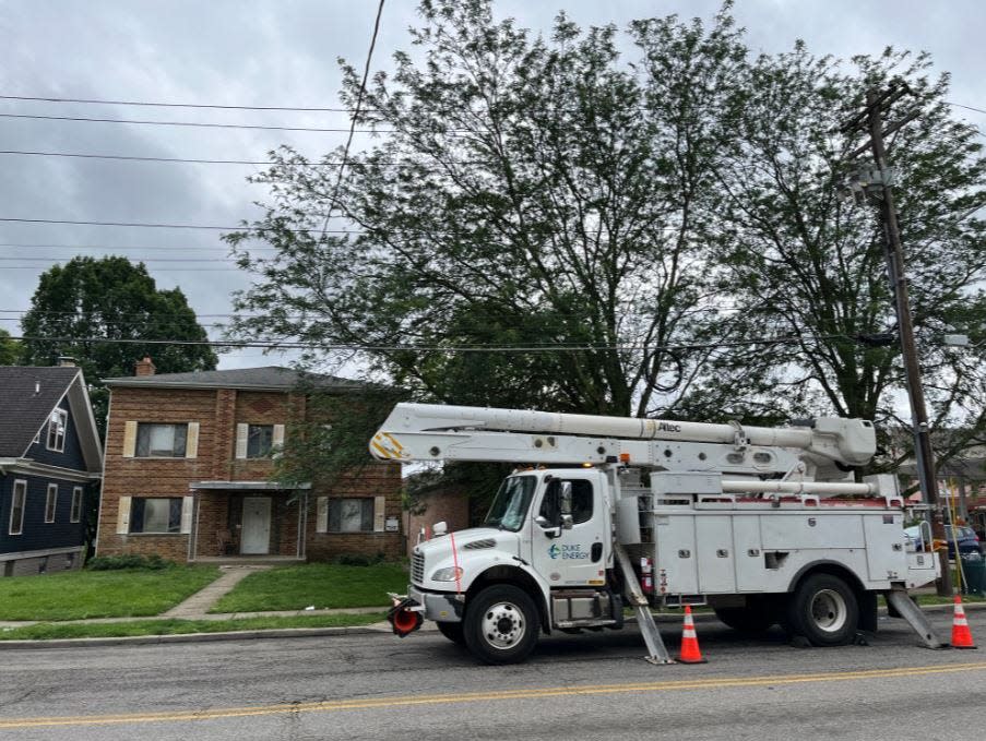 Duke energy crews work on damaged power lines at Glenmore and Montana avenues, as thousands were without power following Sunday's storms.