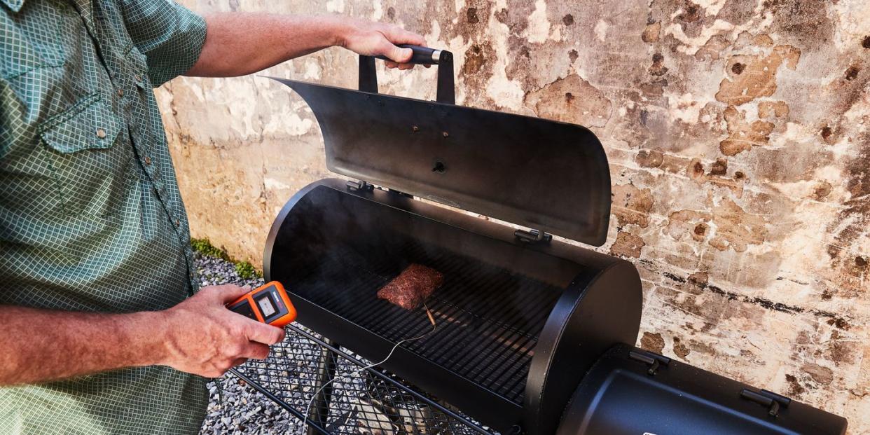 man using thermopro meat thermometer