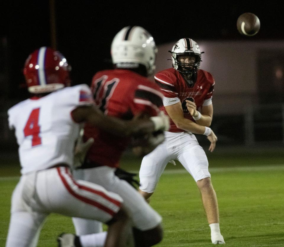 West Florida quarterback John Nicholas (No. 9) delivers a strike to receiver Joseph Jones (No.11) during Friday night game against Pine Forest High School.