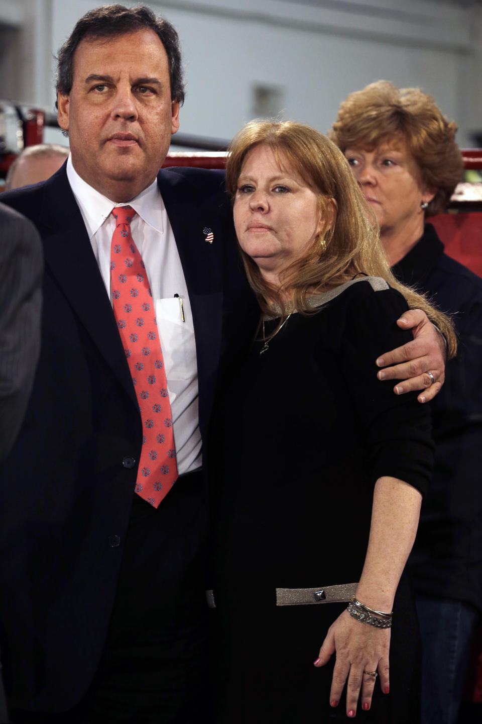 New Jersey Gov. Chris Christie hugs Amy Peters, of Manahawkin Thursday, Jan. 16, 2014, in Manahawkin, N.J., as he meets with homeowners who lost their homes last year to Superstorm Sandy. Christie spoke to Superstorm Sandy victims one week after the meeting was hastily canceled because of a scandal over traffic jams that appear to have been manufactured by his aides. Christie and Community Affairs Commissioner Richard Constable III announced a Sandy housing recovery milestone Thursday as the governor seeks to put the traffic scandal behind him. (AP Photo/Mel Evans)