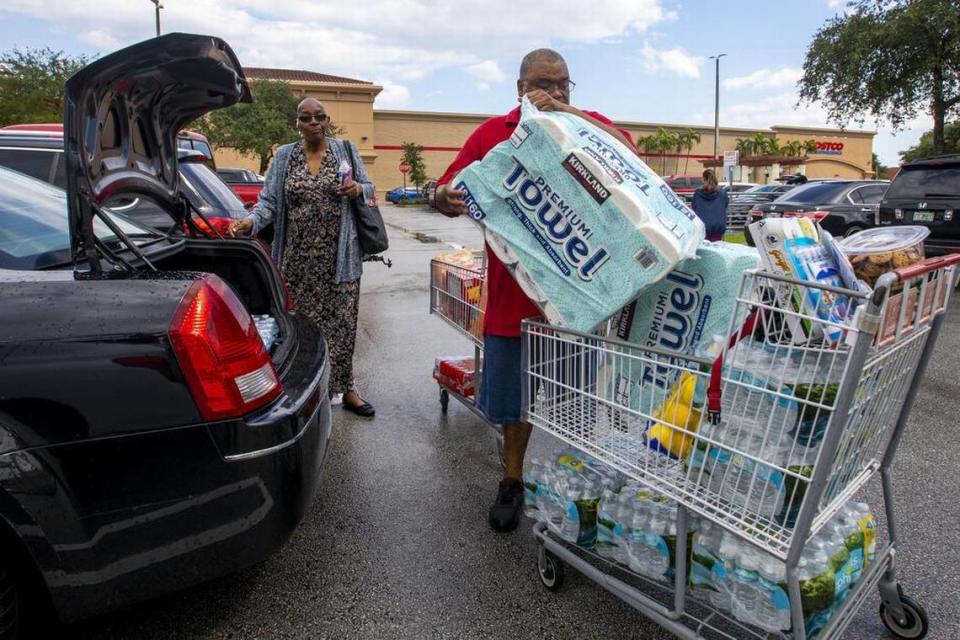 Miami-Dade county residents Jackie and James Silva load their car after shopping to prepare for potential landfall by Hurricane Ian at Costco in Miami, Florida, on Saturday, September 25, 2022. The Silvas were shopping to assist friends and family who might be in need of extra supplies.