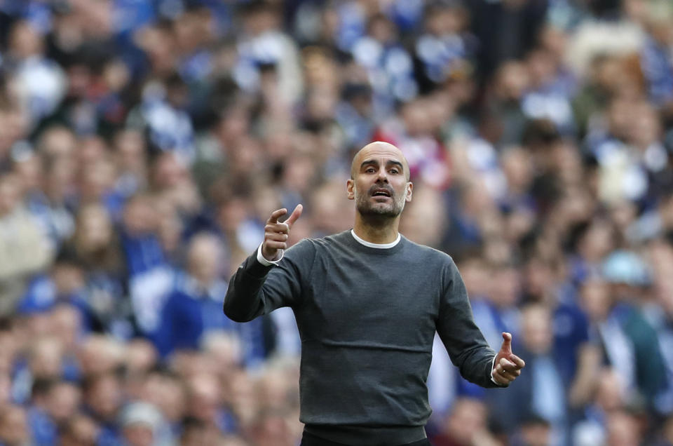 Manchester City manager Pep Guardiola gestures during the English League Cup final soccer match between Chelsea and Manchester City at Wembley stadium in London, England, Sunday, Feb. 24, 2019. (AP Photo/Alastair Grant)